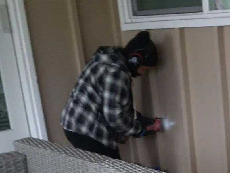 Professional electrician installing an exterior outlet in Bellevue